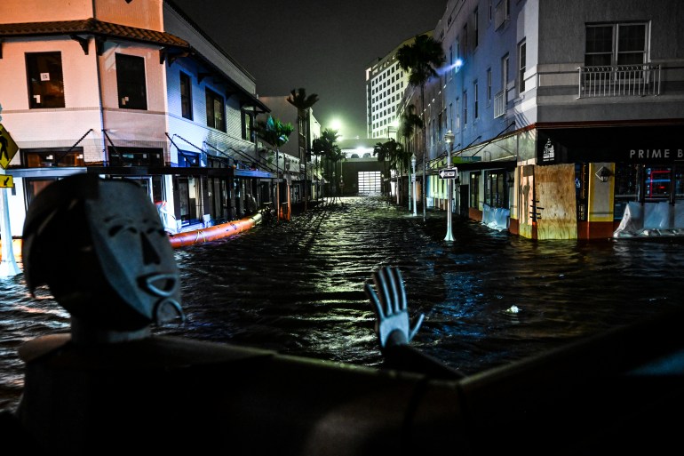 Water-flooded streets are seen after Hurricane Milton made landfall in Fort Myers, Florida, on October 9, 2024. - Milton made landfall in Florida October 9, 2024 as an "extremely dangerous" Category 3 hurricane, packing life-threatening storm surge, extreme winds and flash flooding, the National Hurricane Center (NHC) said. "Data indicate the eye of Hurricane Milton has made landfall near Siesta Key in Sarasota County along the west coast of Florida," the NHC said in an 8:30 pm (0030 GMT Thursday) bulletin. (Photo by CHANDAN KHANNA / AFP)