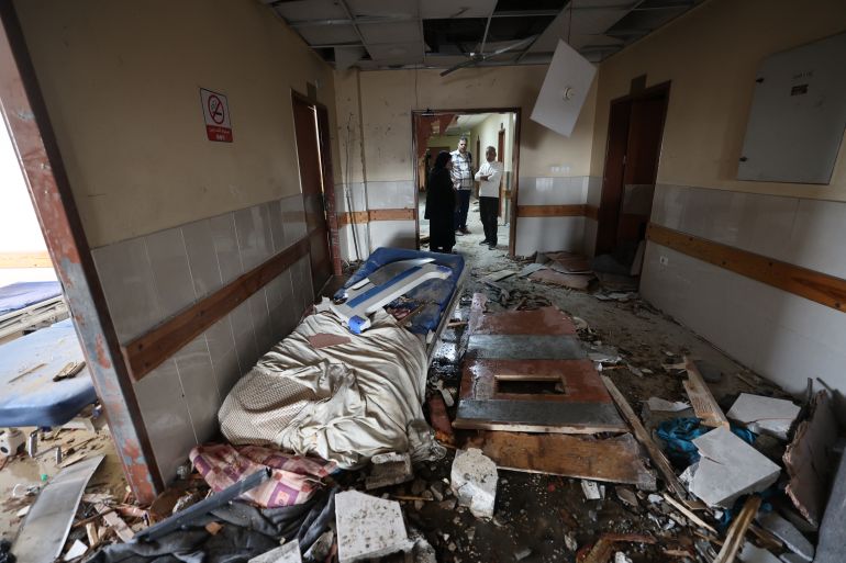TOPSHOT - Palestinians inspect the destruction inside Nasser hospital in Khan Yunis in the southern Gaza Strip following an Israeli strike early on May 13, 2025, in which Palestinian journalist Hassan Aslih was killed along with several others.