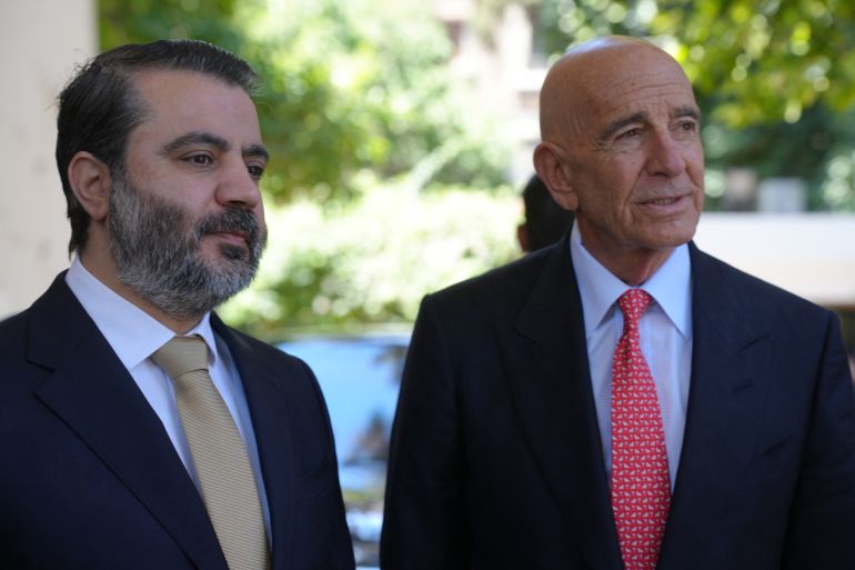 Syria's Foreign Minister Assaad al-Shibani and US special envoy for Syria, the ambassador to Turkey Thomas Barrack (R), attend a flag-raising ceremony at the US ambassador's residence in Damascus on May 29, 2025.