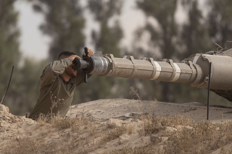 SOUTHERN ISRAEL, ISRAEL - MAY 19: An Israeli soldier works on a tank cannon near the border with the Gaza Strip on May 19, 2025 in Southern Israel, Israel. The Israeli military has said its expanding ground operations in Gaza as part of what they're calling 'Operation Gideon's Chariots,' aimed at securing the release of hostages still held in Gaza, as well as "the defeat of Hamas." Israel has been escalating its campaign in Gaza and blockade of humanitarian aid after the previous two-month long ceasefire agreement collapsed in March. Meanwhile, over the weekend the two sides reportedly began indirect talks to reach a ceasefire in Doha, the capital of Qatar. (Photo by Amir Levy/Getty Images)