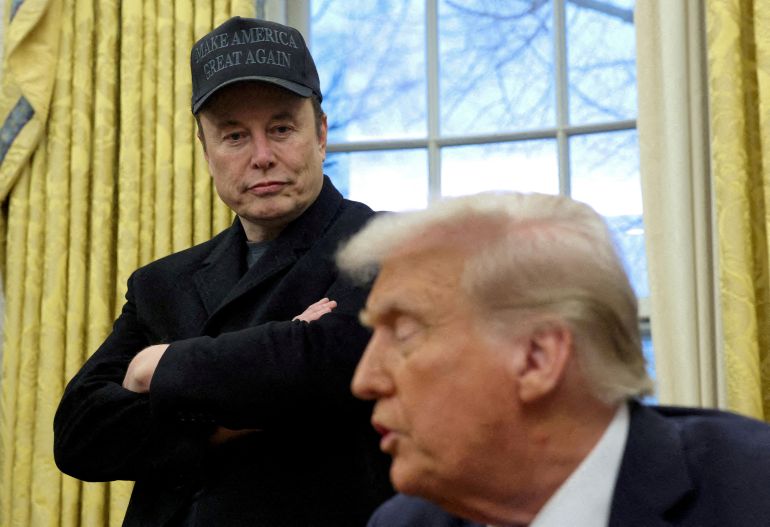 FILE PHOTO: Elon Musk listens to U.S. President Donald Trump speak in the Oval Office of the White House in Washington, D.C., U.S., February 11, 2025. REUTERS/Kevin Lamarque/File Photo