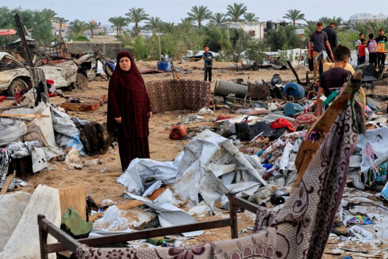 Palestinians inspect the damage at the site of an Israeli strike on a tent camp sheltering displaced people, in Khan Younis, southern Gaza Strip, May 18, 2025. REUTERS/Hatem Khaled TPX IMAGES OF THE DAY
