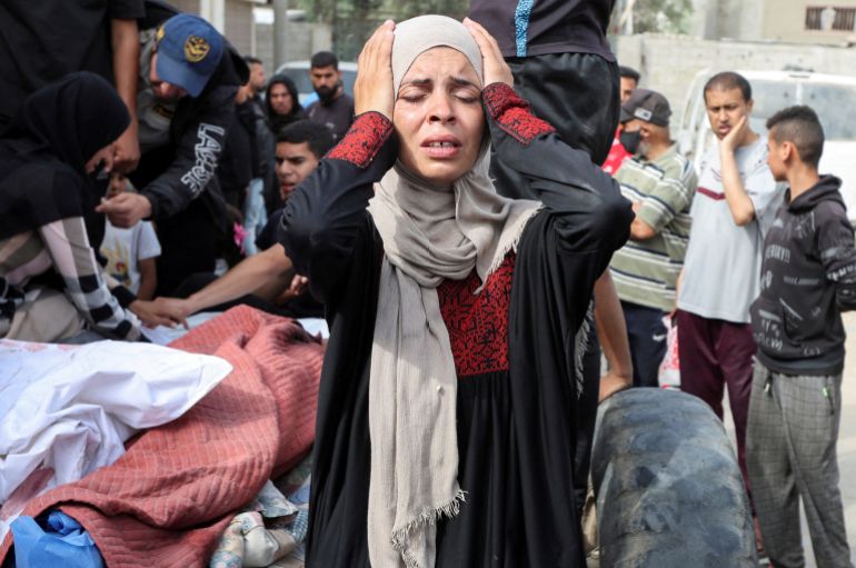 A woman reacts during the funeral of Palestinians killed in Israeli strikes, at Al-Aqsa Martyrs hospital, in Deir Al-Balah in the central Gaza Strip, May 18, 2025. REUTERS/Ramadan Abed TPX IMAGES OF THE DAY