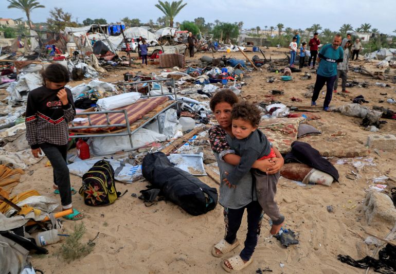 Palestinians inspect the damage at the site of an Israeli strike on a tent camp sheltering displaced people, in Khan Younis, southern Gaza Strip, May 18, 2025. REUTERS/Hatem Khaled TPX IMAGES OF THE DAY