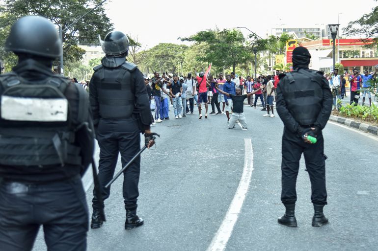 Angola's Rapid Intervention Force (PIR) stand guard as protesters gather during a protest against the rise in fuel prices and transport costs in Luanda on July 12, 2025. (Photo by Julio PACHECO NTELA / AFP)