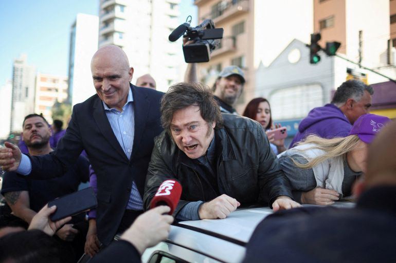 Argentina's President Javier Milei speaks to the media, while standing on a vehicle with lawmaker Jose Luis Espert to attend a La Libertad Avanza party rally ahead of legislative elections in the province of Buenos Aires, in Lomas de Zamora on the outskirts of Buenos Aires, Argentina, August 27, 2025. REUTERS/Agustin Marcarian