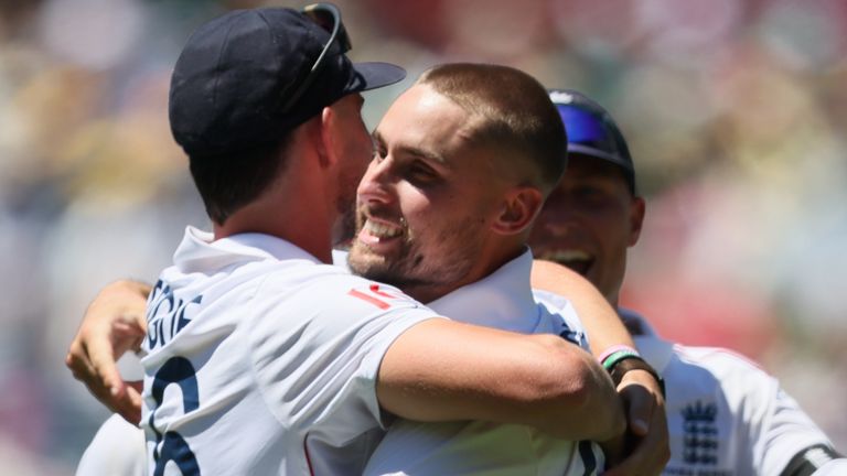 England's Josh Tongue, left, and England's Will Jacks celebrates the wicket of Australia's Usman Khawaja during play on day one of the third Ashes cricket test between England and Australia at the Adelaide Oval in Adelaide, Australia, Wednesday, Dec. 17, 2025. (AP Photo/James Elsby)